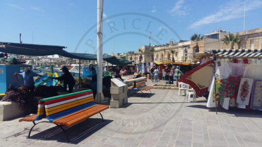 Marsaxlokk, Malta. At the waterfront of Marsaxlokk it is possible to see fishermen working, hawkers seeling souvenirs and restaurants. Even if it’s a good for the tourist, the use of the space creates sometimes conflicts between the users (Photo: Jordi Vegas Macias).